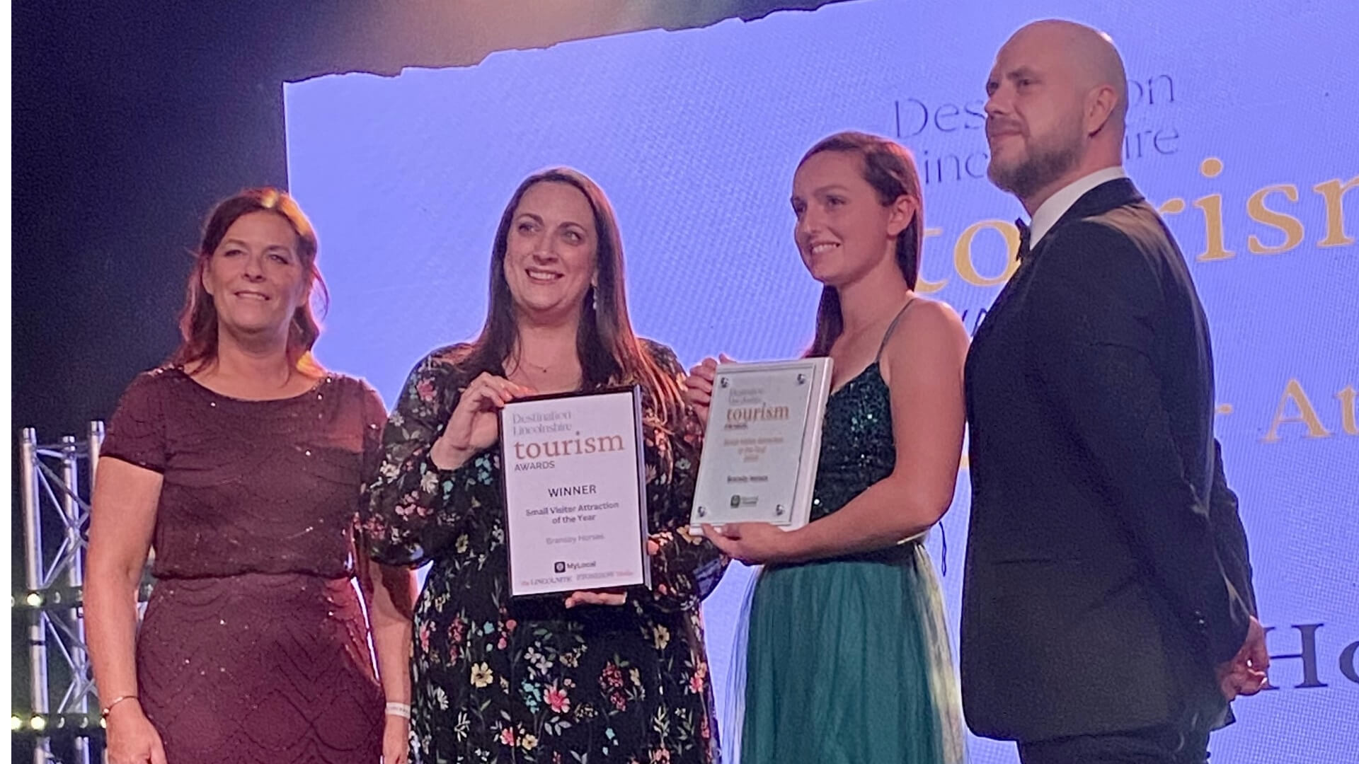 members of staff holding an award at the destination lincoln awards evening