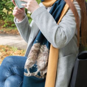 woman wearing a wrendale cuddling owls scarf