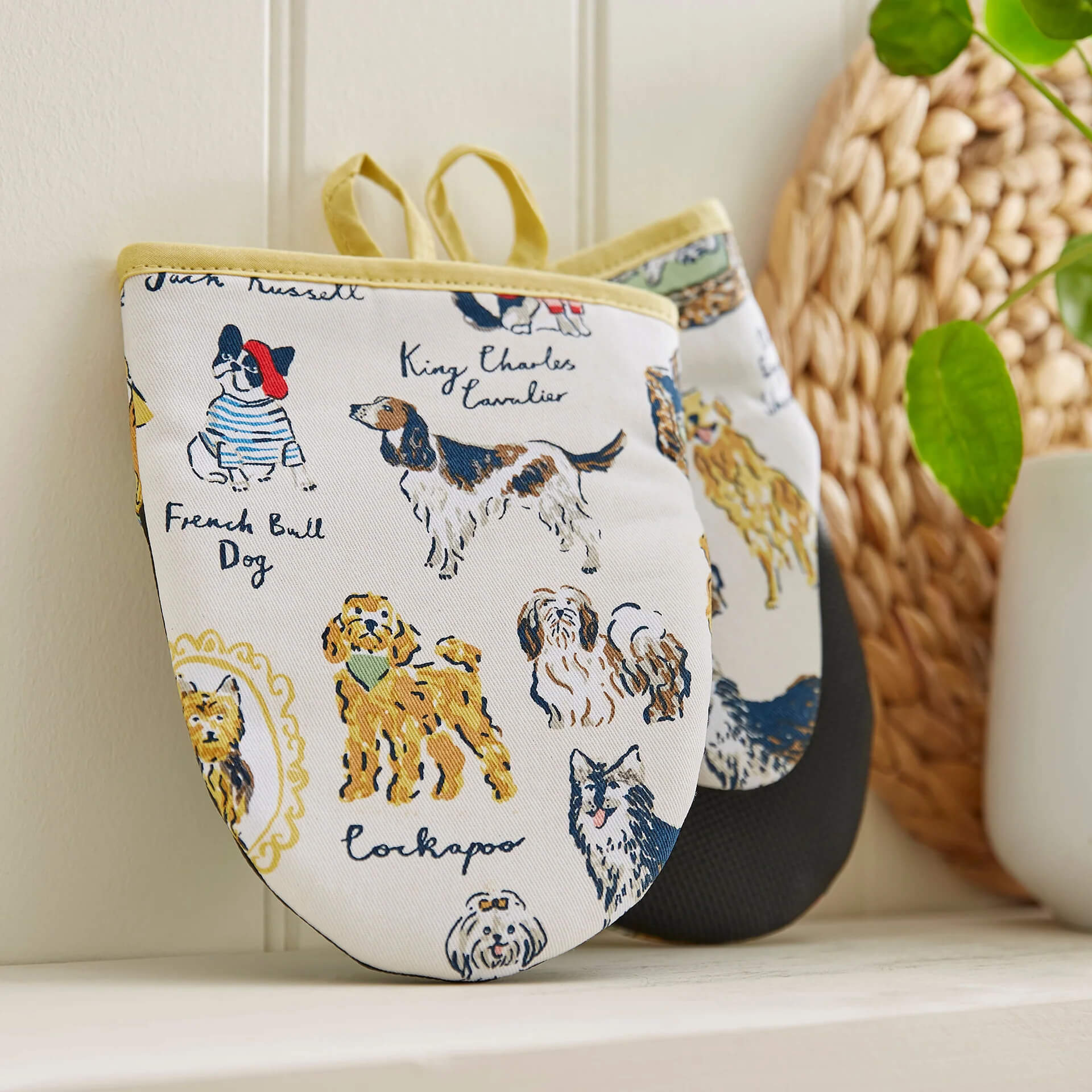 microwave mitts with various breeds of dog on them